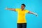 Joyful Plus-Size Black Woman Spreading Hands For Hug, Blue Background