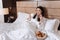 Joyful positive woman eating a croissant