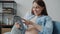 Joyful pregnant lady touching tablet screen and smiling enjoying technology at home