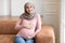 Joyful Pregnant Muslim Woman Wearing Hijab Touching Belly At Home