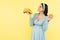 joyful pregnant woman holding ripe bananas