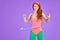 Joyful red-haired slim girl rotates hula hoop