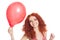 Joyful redhead girl holding red balloon