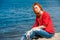 Joyful redhead woman sitting comfortably and smiling