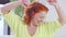 Joyful relaxed redhead woman enjoying music in headphones indoors. Portrait of happy cheerful adult Caucasian lady