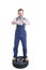 Joyful repairman on tire holding crossed wrench