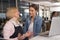 Joyful restaurateur talking with her waitress