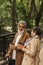 joyful retired couple in beige coats