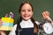 joyful schoolgirl showing pen holder and