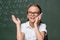 joyful schoolgirl talking on smartphone near