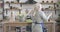 Joyful senior Caucasian woman dancing with cooking utilities in modern kitchen. Portrait of cheerful middle-aged retiree