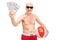 Joyful senior man holding money and a beach ball