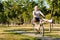 Joyful senior woman riding a bicycle