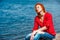 Joyful serene redhead woman sitting comfortably