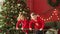 Joyful siblings kid boy and little girl wearing pyjamas jumping on bed on background of christmas tree on xmas holidays