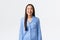 Joyful smiling asian girl in blue pajamas looking upbeat, going sleep. brush teeth and wink satisfied, getting ready bed