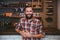 Joyful smiling bearded man posing in barbershop