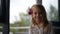 Joyful smiling preschool girl sitting on the sofa