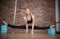 Joyful talented woman diligently doing the splits in pole dance studio