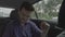 Joyful teen man dancing inside travel car happy to going on road trip holiday -
