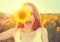 Joyful teenage girl with sunflower