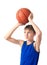 Joyful teenager holding a ball for basketball over his head. Is