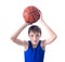 Joyful teenager holding a ball for basketball over his head. Is