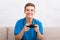 Joyful teenager playing console with joystick in hands