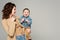 joyful toddler boy holding glasses while