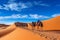 Joyful Tourist on Group Camel Ride in Desert