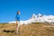 Joyful traveler walks along the mountain slope