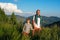 Joyful travelers: a man and a boy are standing on a alpine meadow