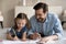 Joyful two different generations family drawing pictures.