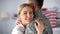 Joyful wife hugging military husband and smiling at camera, homecoming after war