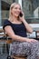 Joyful Woman Chatting on the Phone at an Outdoor Cafe