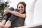 Joyful woman on couch, bare feet pointed