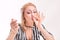 Joyful woman eating insects with a fork in a restaurant