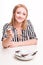 Joyful woman eating insects with a fork in a restaurant