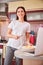 Joyful woman holding a fork and picking up a plate