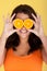 Joyful Woman With Orange Slices Over Eyes