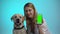 Joyful woman with purebred dog showing cellphone on camera, pet adoption app