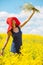 Joyful woman in a red hat with a bouquet of wild flowers