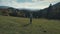 Joyful woman running carpatian mountain valley