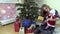 Joyful woman show her lovely baby gift box near Christmas tree