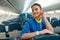 Joyful woman stewardess standing in airplane passenger salon