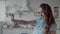 Joyful woman taking selfie photo in modern kitchen. Girl posing for photo.