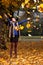 Joyful woman throwing autumn leaves