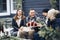 Joyful young family couple gathering with friends around campfire in winter