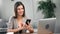 Joyful young woman chatting use smartphone enjoying break. Medium shot on RED camera