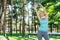 Joyful young woman exercising alone in the park